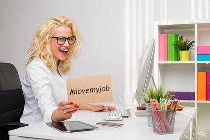 photo : Woman in office showing "I love my job" cardboard