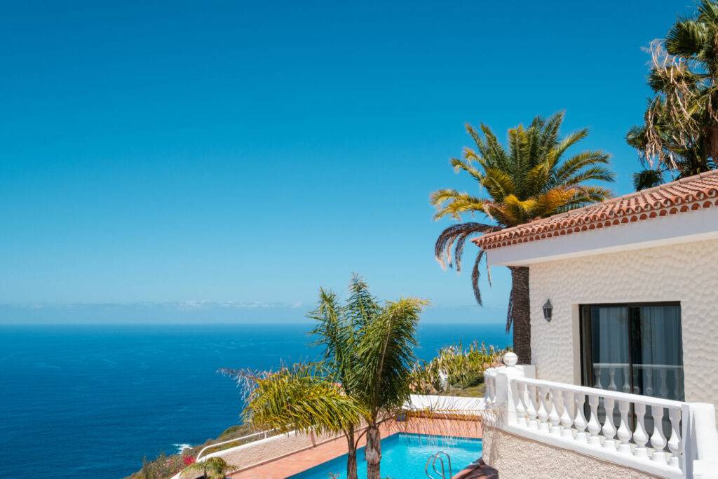 photo : house with swimming pool, palm trees and ocean sea view