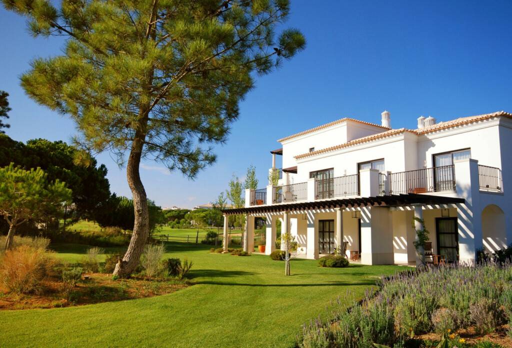 photo : white luxury villa, lawn and pine