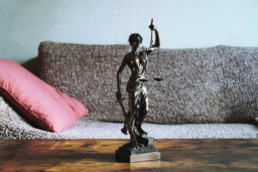 photo : lady justice or justitia statue on table - landlord and tenant law