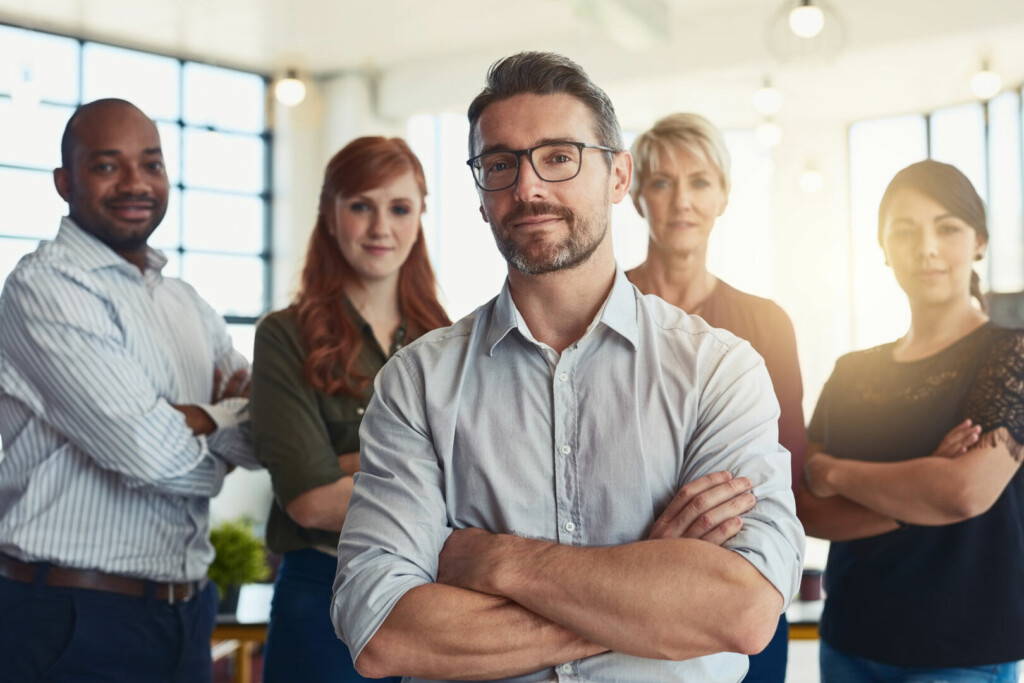 photo : Leading the way to excellence. Portrait of a group of designers standing in an office.