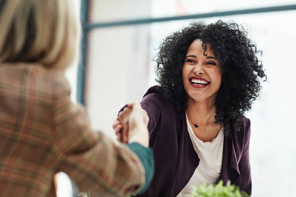 photo : Handshake with a happy, confident and excited business woman or human resources manager and a female colleague, partner or employee. An agreement, deal or meeting with a coworker in the boardroom