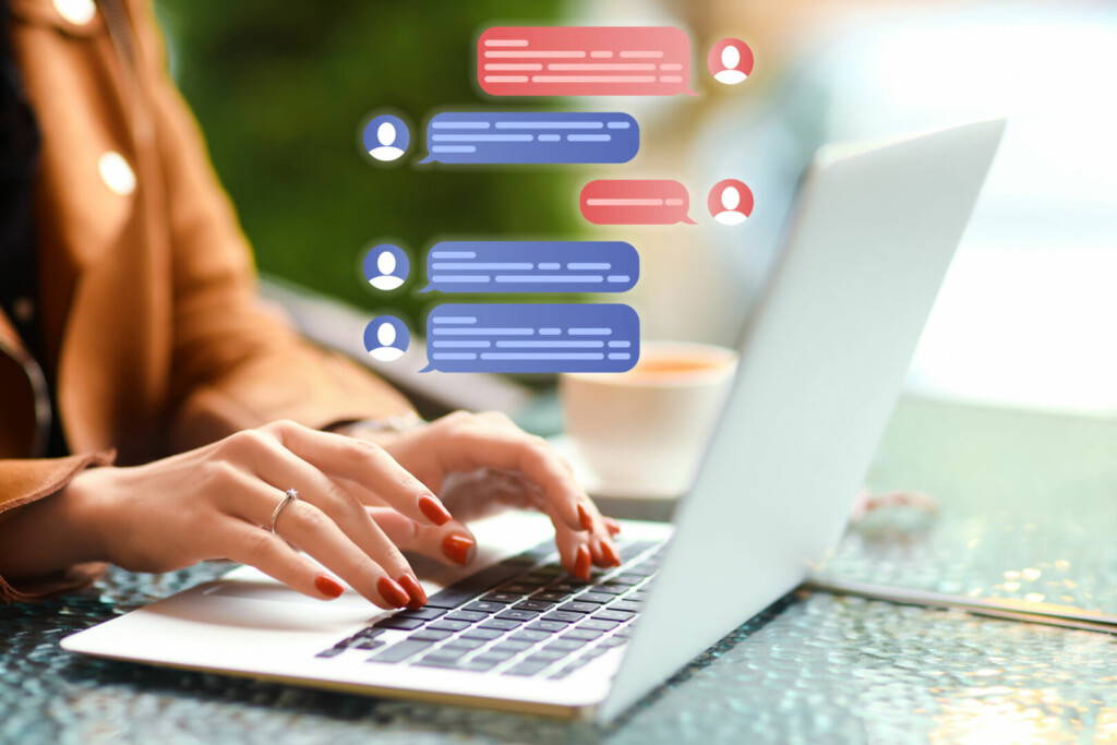 photo : Woman with laptop chatting online at table in cafe