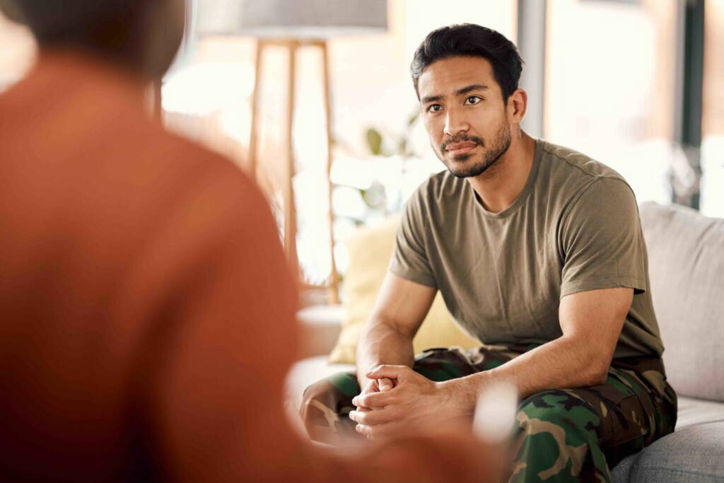 photo : Listen, therapy and a military man with a psychologist for counselling, support and psychology. Young army, veteran or soldier person on therapist couch for mental health, consultation or help